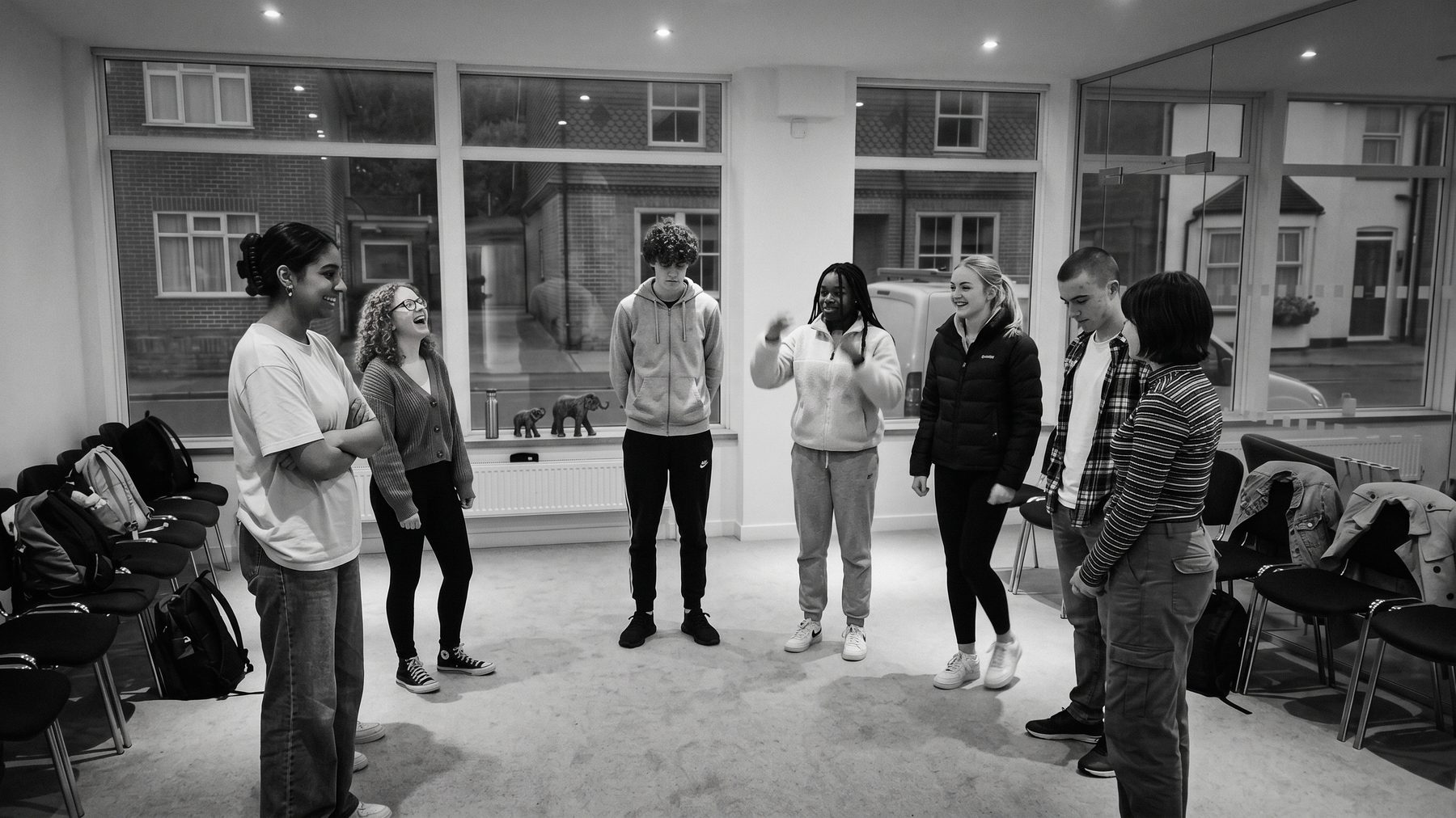 A group standing in a loose circle in the room at Kings Road
